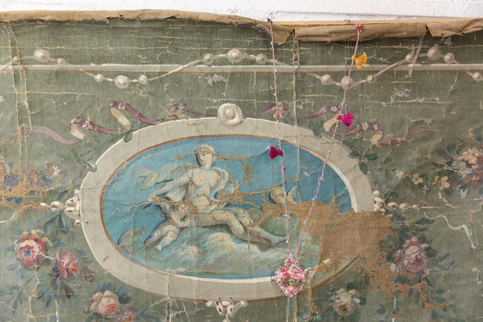 Magnolia Pearl artisan necklace with whimsical boho charms on vintage floral mural background