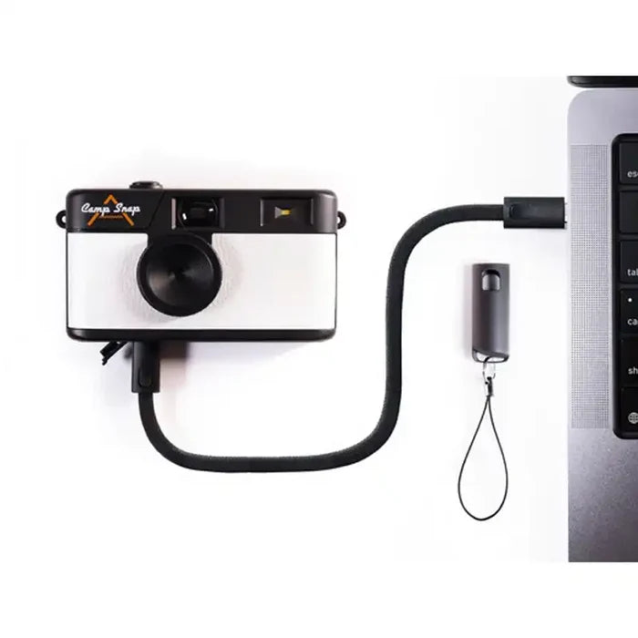 Camera with strap connected to laptop