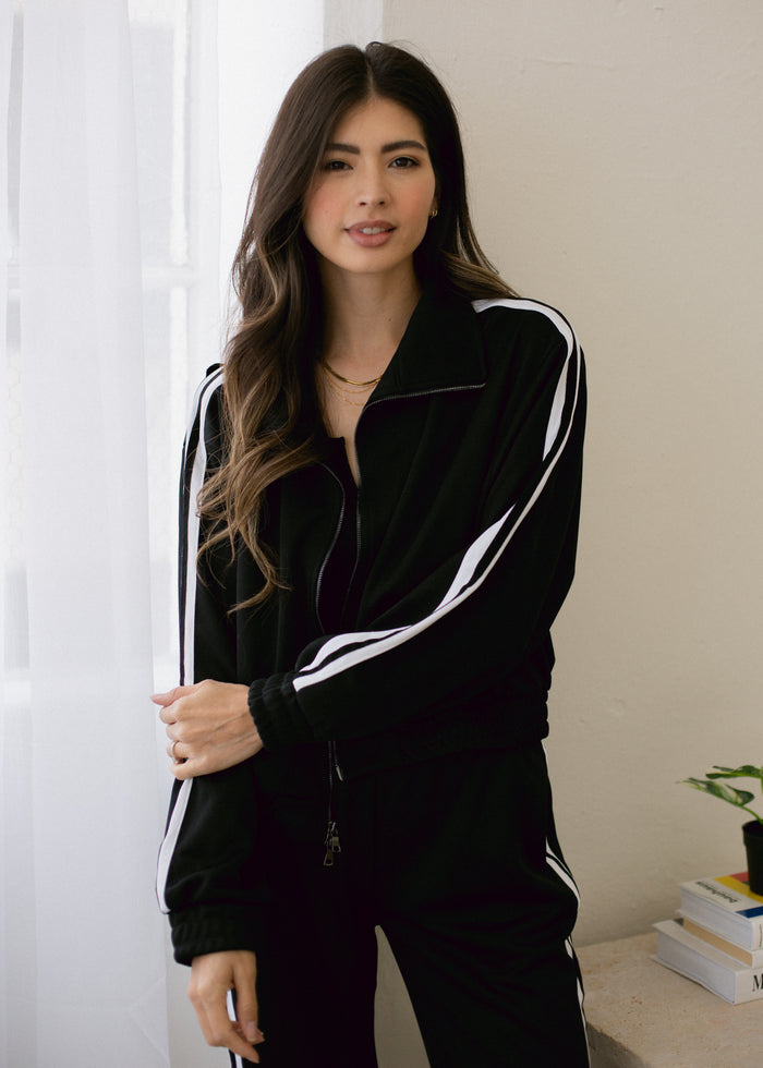 Back view of Cropped Track Jacket in black on model