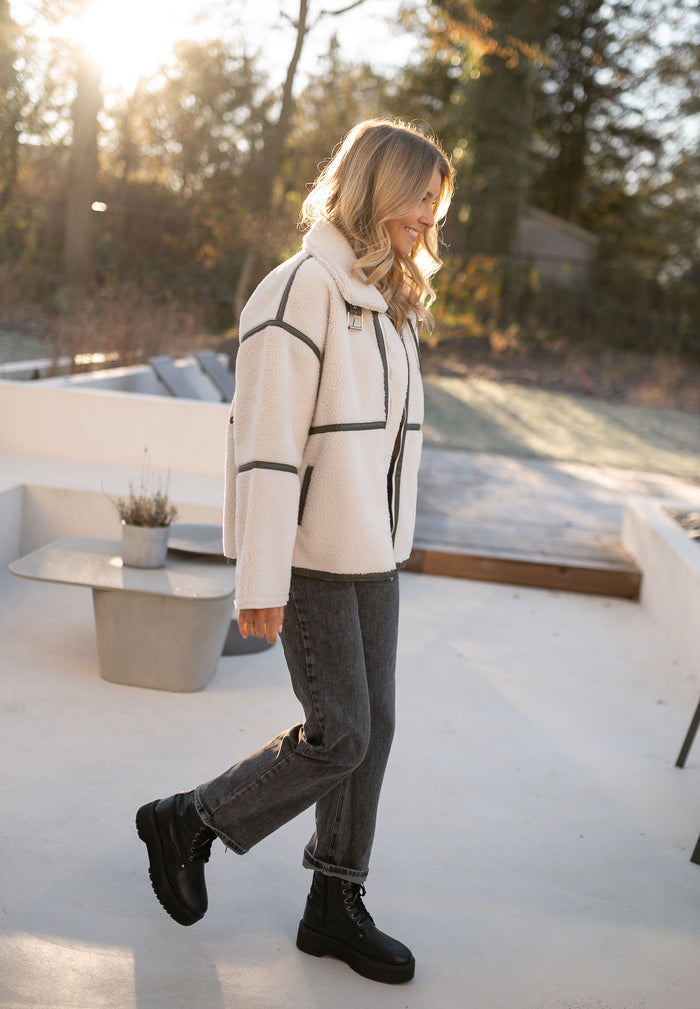 Cream teddy shearling jacket styled with grey jeans