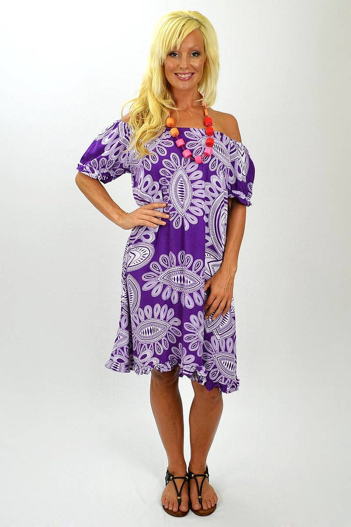 Misha purple and white patterned tunic with long sleeves and flowing fabric, displayed on a hanger.