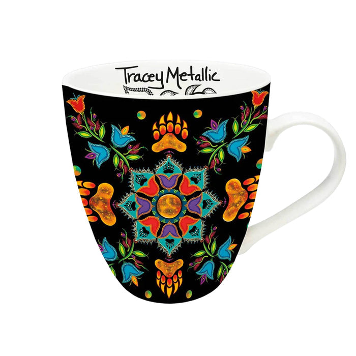 Mug with colorful mandala design on a black background, featuring the brand 'Tracey Metallic'.