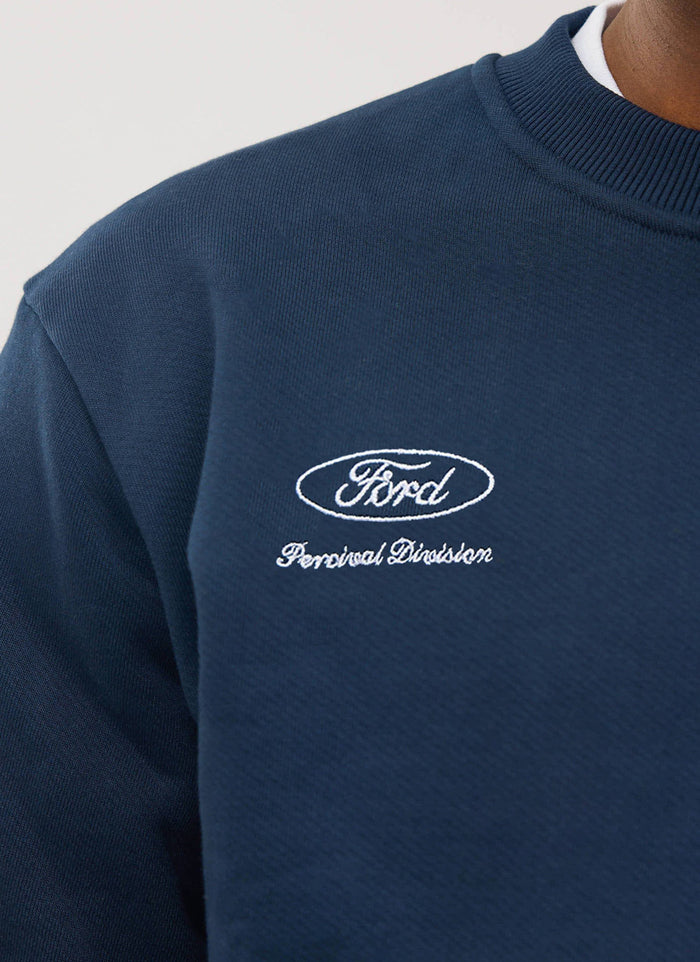 Close-up detail of the white Ford and Percival Division embroidery on the navy Percival x Ford collaboration sweatshirt.