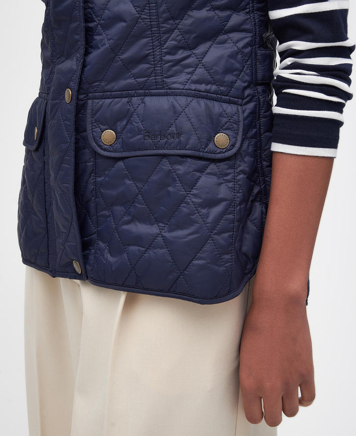 Navy quilted vest worn by a person on a white background