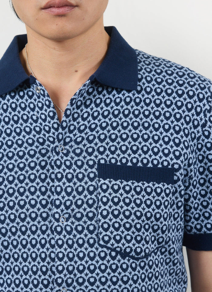Close-up of a model wearing the Percival Casa Piccante Shirt in blue jacquard, highlighting the knitted texture and pocket.