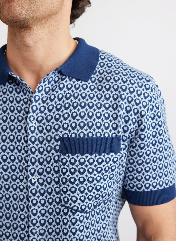 Close up of the Percival Casa Piccante blue jacquard knitted shirt showing the collar, pocket and snap button details.