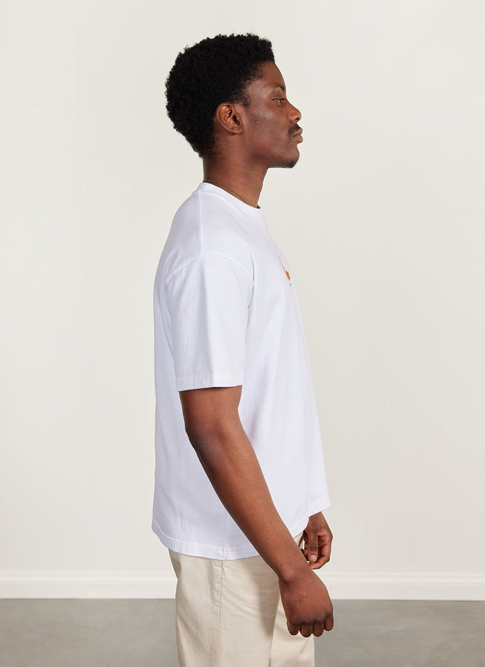 Side profile of a model wearing the Percival Citrus Oversized T-Shirt in white organic cotton.