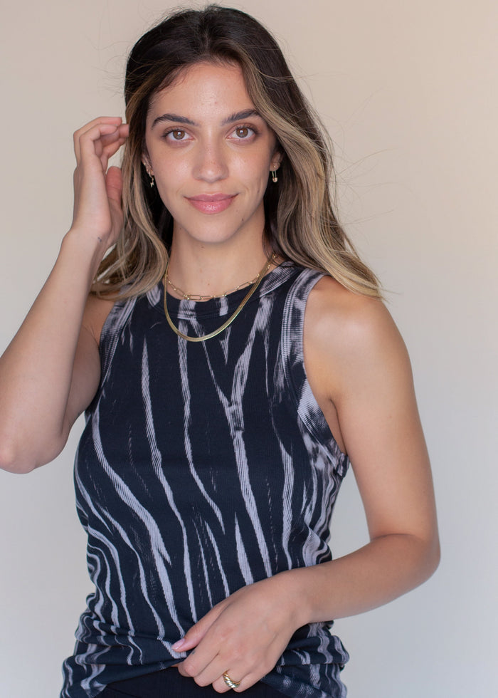 woman wearing rib tank with binding details in black tie dye