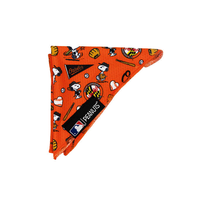 The Sassy Woof Dog Bandana - MLB™ x Peanuts™ Baltimore Orioles™ is an orange bandana with Peanuts characters, baseball details, and an Orioles pennant—featuring a black MLB Peanuts label for a playful pup accessory.