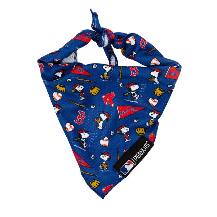 The Sassy Woof Dog Bandana - MLB™ x Peanuts™ Boston Red Sox™ features Snoopy baseball scenes, bats, gloves, and official Red Sox logos on blue fabric, topped with an MLB Peanuts tag.