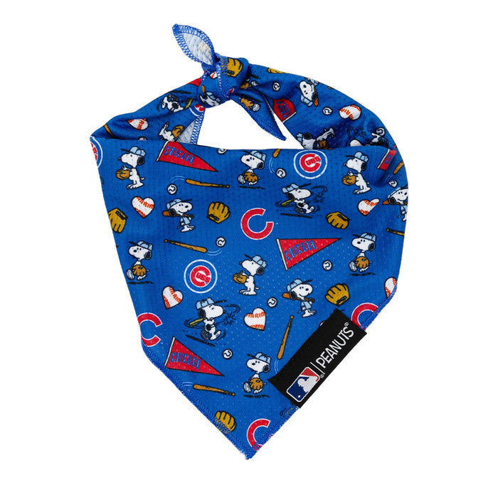 The Sassy Woof Dog Bandana - MLB™ x Peanuts™ Chicago Cubs™ features Snoopy baseball scenes, Woodstock, Cubs logos, baseball motifs, and hearts. Finished with a knotted top and a black LEMHUS/MLB tag at the corner.