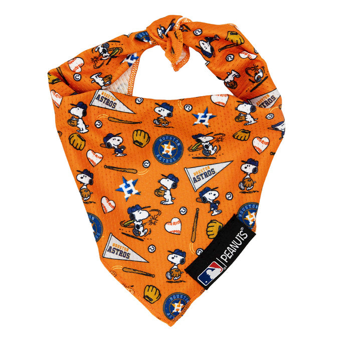 The Sassy Woof Dog Bandana - MLB™ x Peanuts™ Houston Astros™ features Snoopy and Woodstock in Astros gear, baseball icons, team logos, cooling mesh fabric, a black Peanuts tag, and an MLB logo at the bottom.