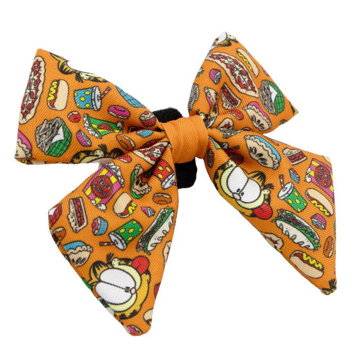The Dog Sailor Bow - Garfield™ by Sassy Woof is a bright orange accessory featuring cute cat faces and cartoon food like hot dogs, sandwiches, and pies—perfect for pairing with other Garfield-themed Sassy Woof gear.
