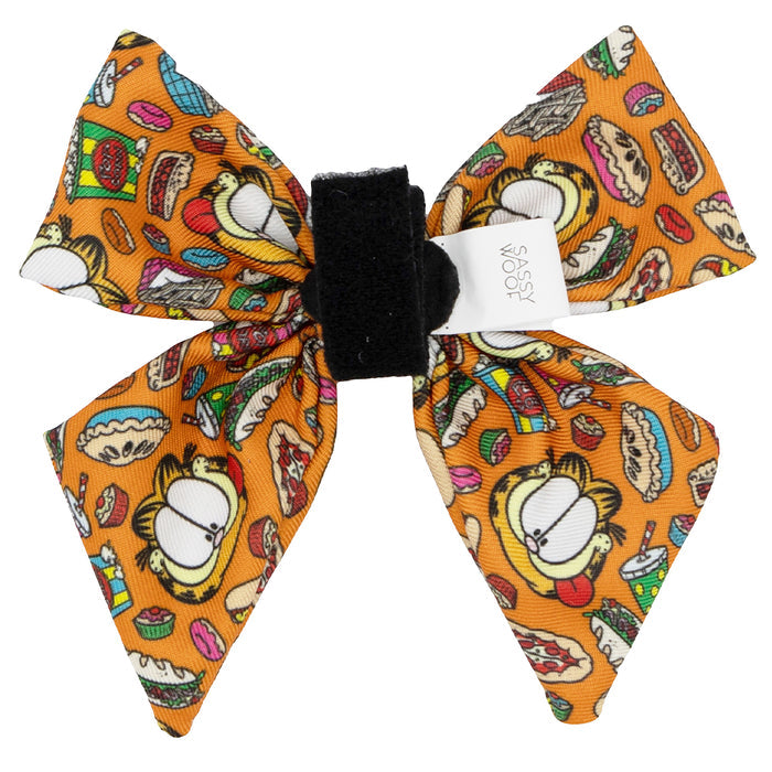 The Sassy Woof Dog Sailor Bow - Garfield™ is an orange bow tie with cartoon Garfield and colorful foods. A white tag is attached at the center. Pair with our food-themed bandana or Garfield dog accessories for a playful set!.