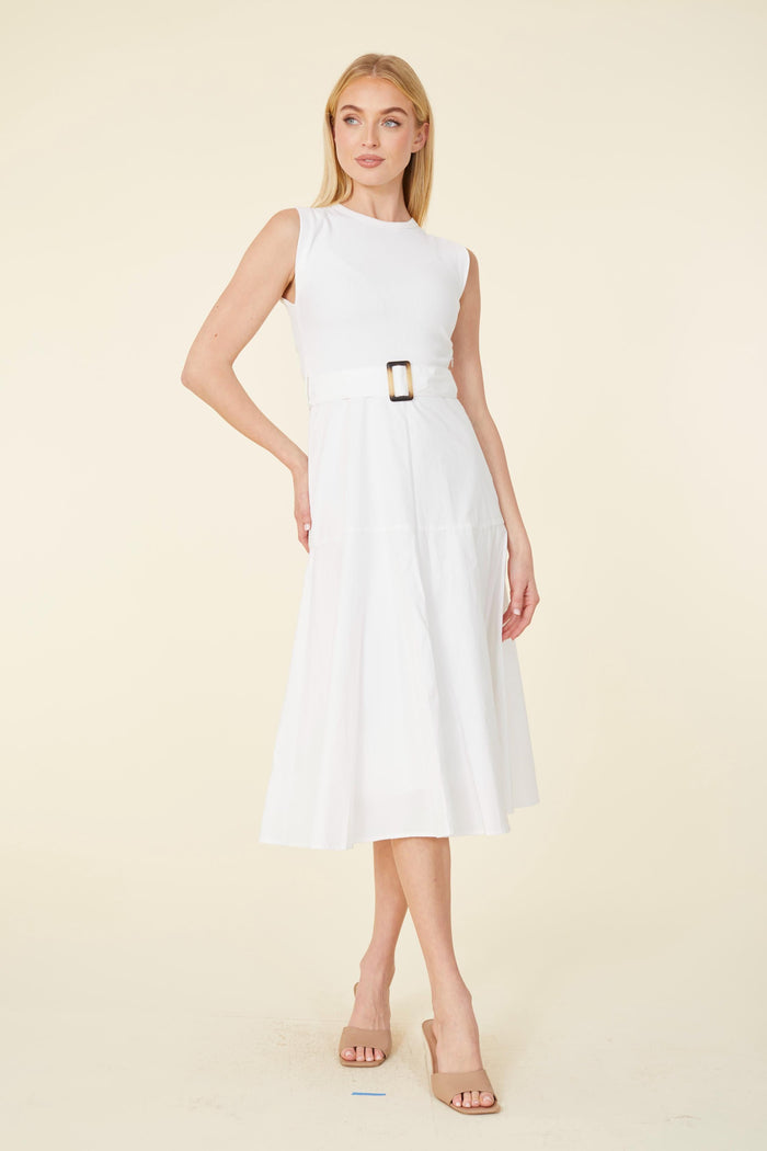 Model in a white dress with a tortoise shell belt buckle