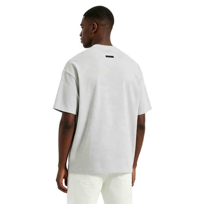 Fear of God Essentials NBA Tee Light Heather worn from the back