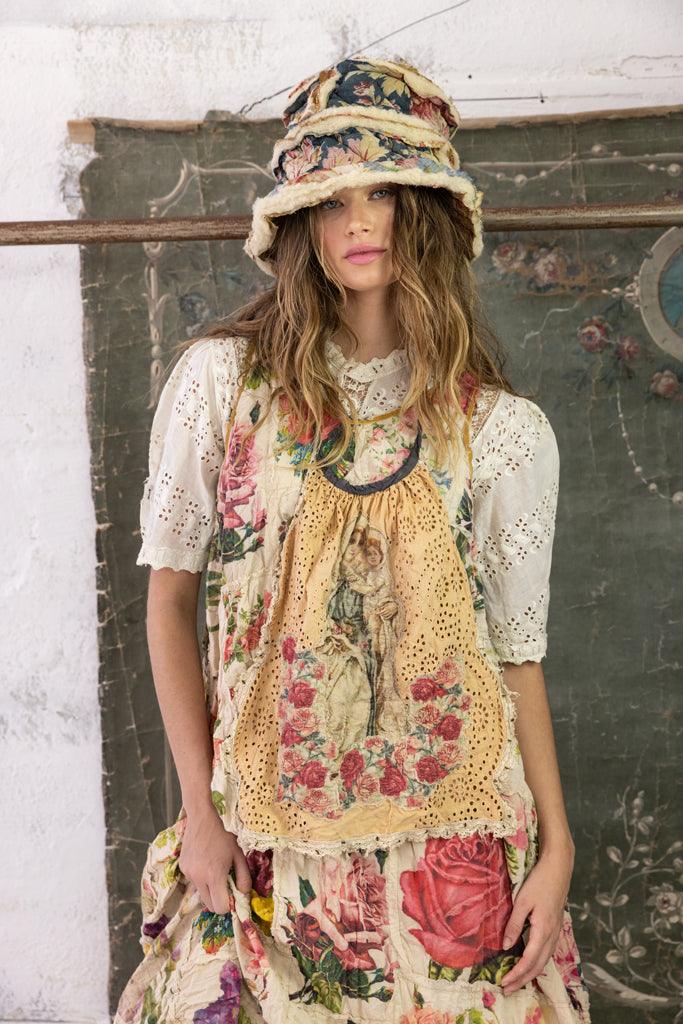 Magnolia Pearl model in whimsical vintage floral dress and brim hat, artisan niche clothing