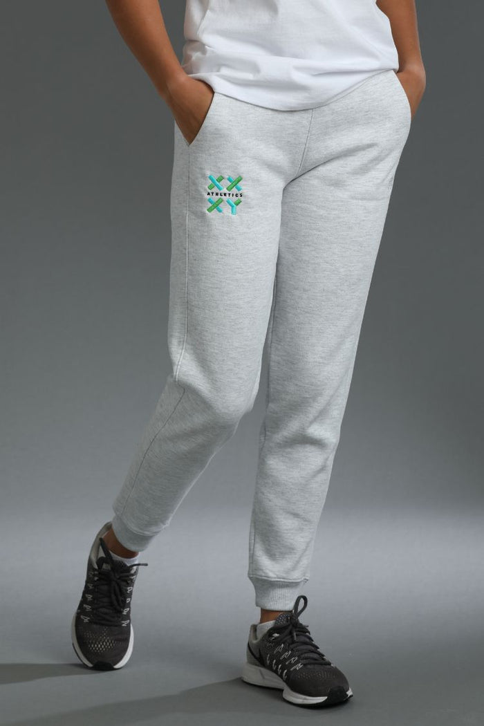 Person wearing gray sweatpants with a logo and white shirt on a gray background || Light Heather Gray