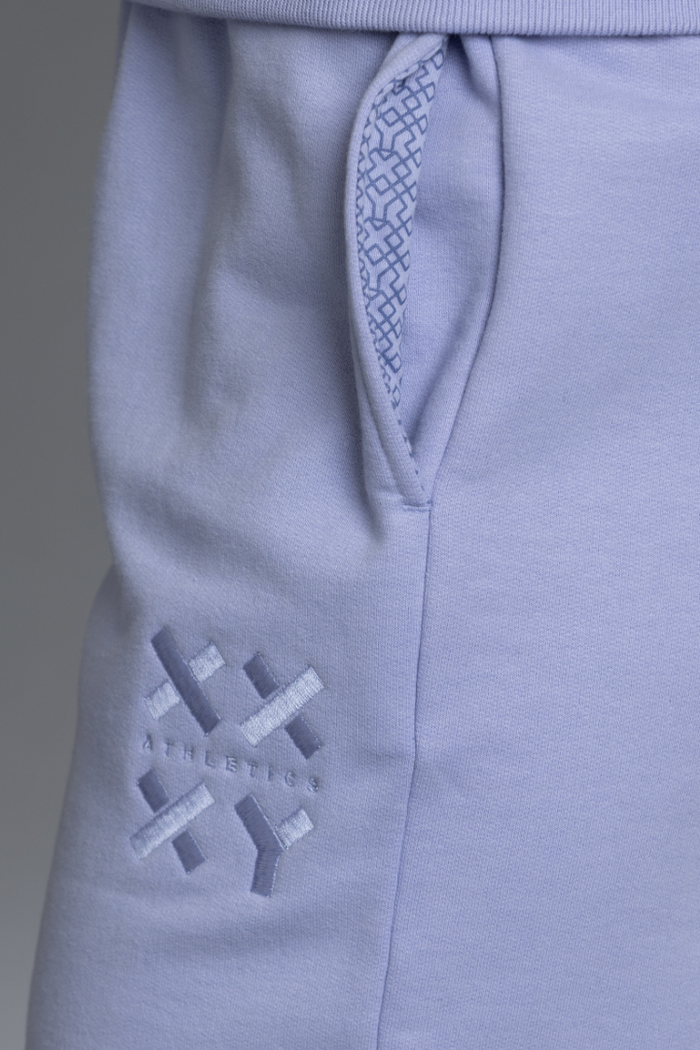 Close-up of lavende sweatpants with a geometric pattern on a gray background || Lavender gray