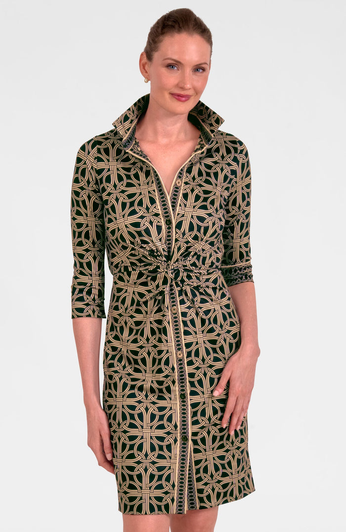 Woman wearing a black and beige patterned dress on a white background