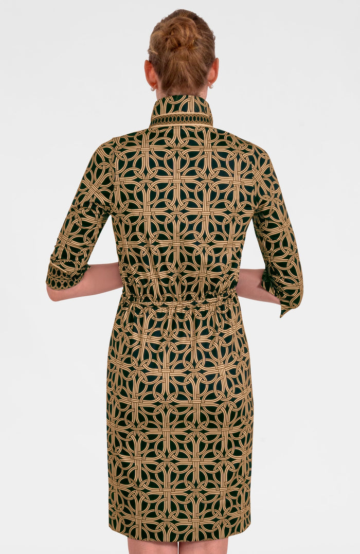 Woman wearing a patterned dress with a geometric design on a white background