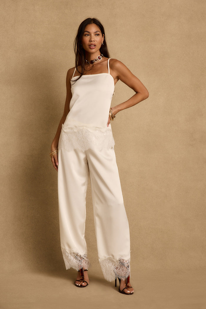 Cream satin wide-leg pants with lace trim hem, styled with matching satin tank.