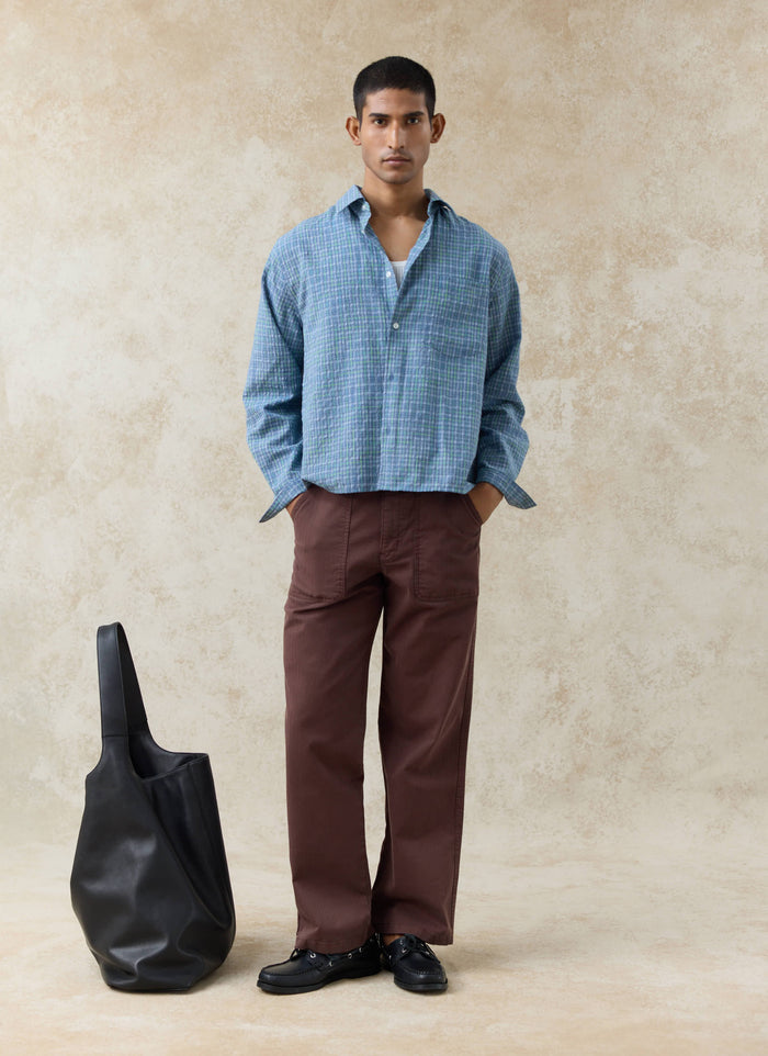 Blue Percival Hinsley Checked Boxy Shirt in textured cotton with espresso brown herringbone straight trousers on a model.
