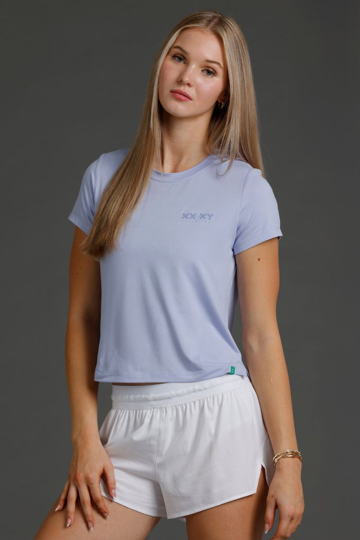 Woman wearing Lavender t-shirt and white shorts || Lavender Gray