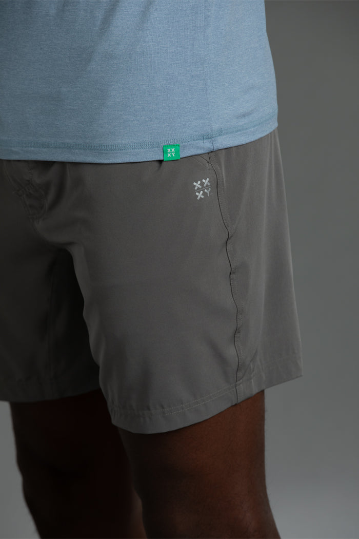 Gray shorts with a brand logo on a gray background || Cerulean Blue Heather