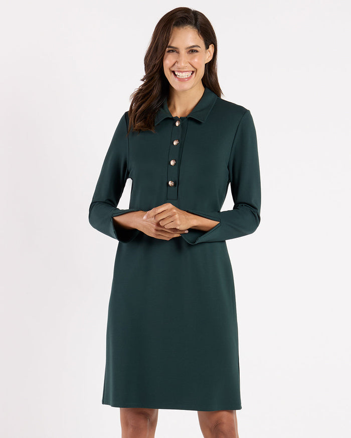 Model in the Jude Connally Midge Dress - Pine/Gold, a dark green dress with gold buttons and a shirt collar