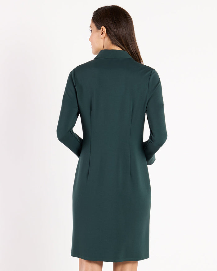 Back view of model in the Jude Connally Midge Dress - Pine/Gold, a dark green dress with gold buttons and a shirt collar