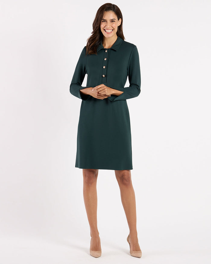 Model in the Jude Connally Midge Dress - Pine/Gold, a dark green dress with gold buttons and a shirt collar