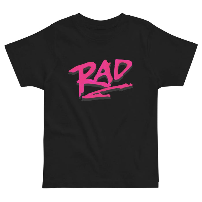 A bold "RAD" graphic dominates this black kids' tee in electric magenta lettering that mimics wet marker strokes or '80s graffiti tags. Contact us with accessibility feedback, we'd love to help!