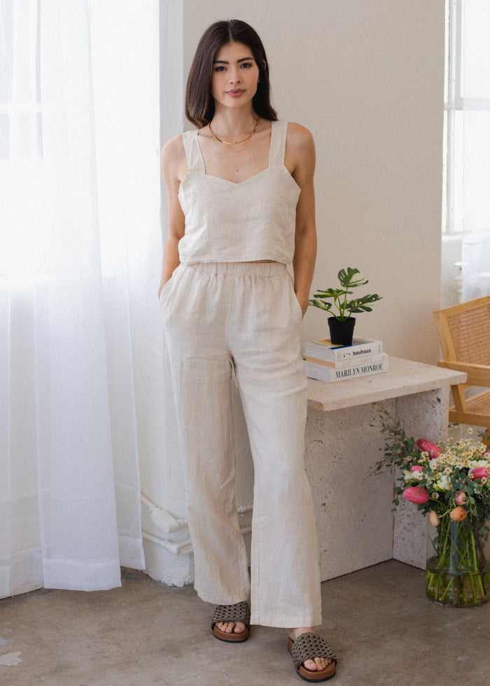 woman wearing wide leg linen pants in cream