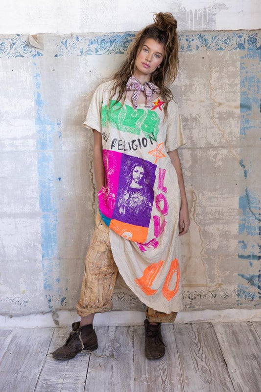 Woman models Magnolia Pearl artisan dress with colorful, whimsical vintage-style graphic design