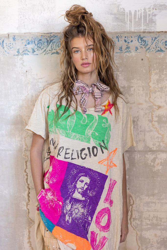 Woman wearing Magnolia Pearl artisan dress with colorful vintage graphic, whimsical design