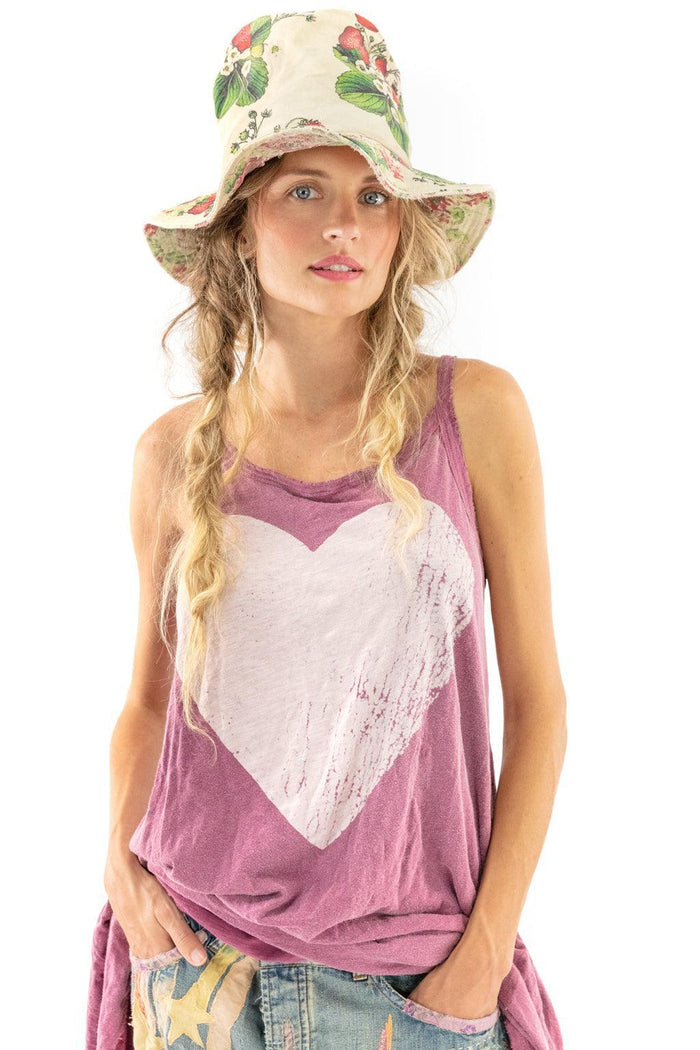 Woman in Magnolia Pearl artisan vintage style heart tank top and floral hat, whimsical fashion