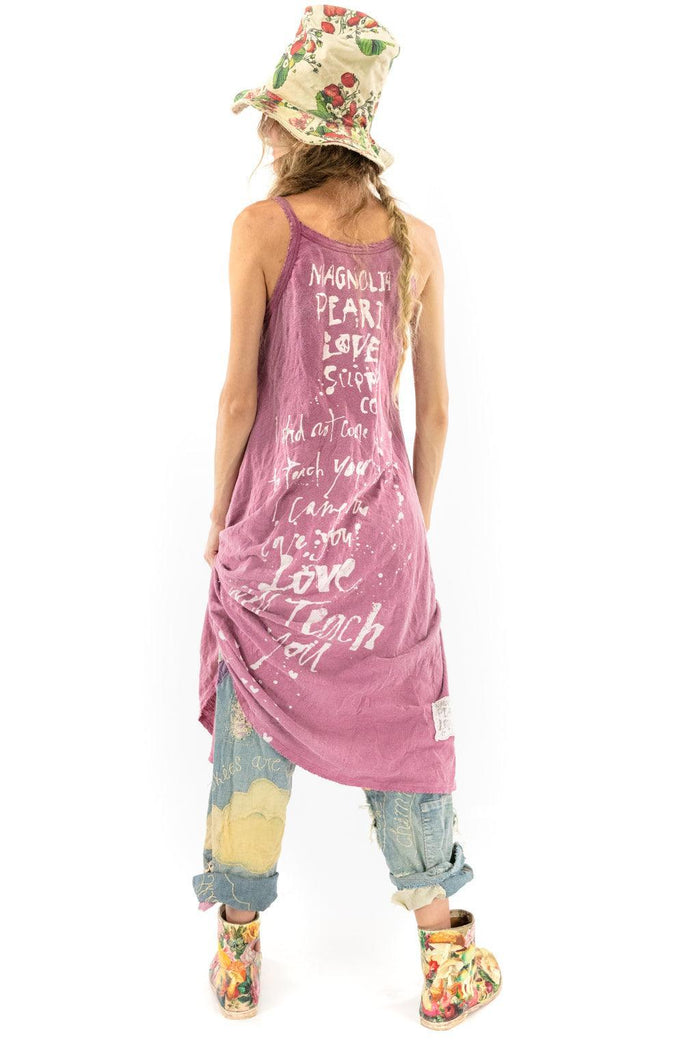 Magnolia Pearl artisan vintage dress with handwritten text, floral hat, and whimsical patchwork jeans