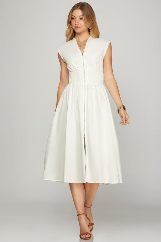 Woman wearing a white sleeveless dress on a gray background