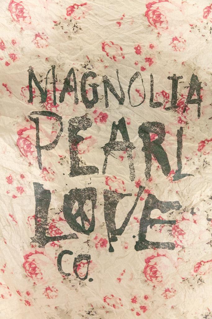 Magnolia Pearl artisan scarf with whimsical vintage floral print and hand-lettered logo