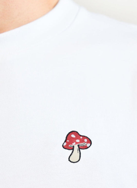 Close up of the mushroom embroidery on the white Percival t shirt.
