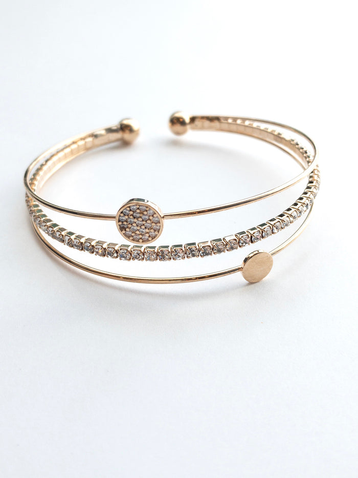 Gold cuff with a sparkly band a simple circle band and a sparkly circle band