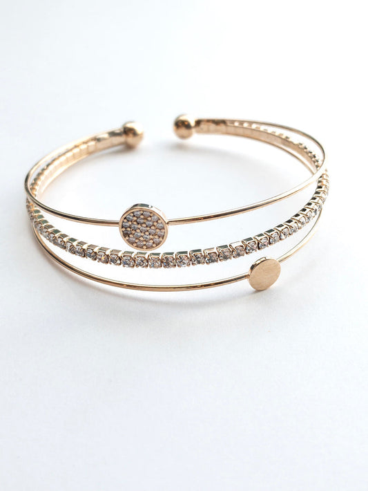 Gold cuff with a sparkly band a simple circle band and a sparkly circle band