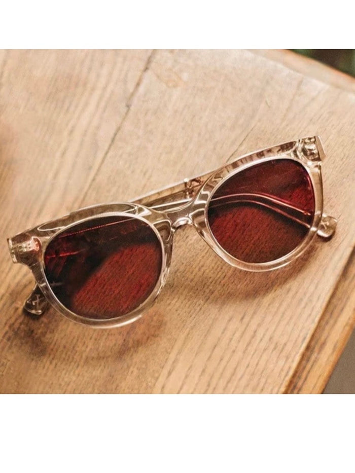 A pair of rose-colored sunglasses with a paisley pattern, displayed against a neutral background.