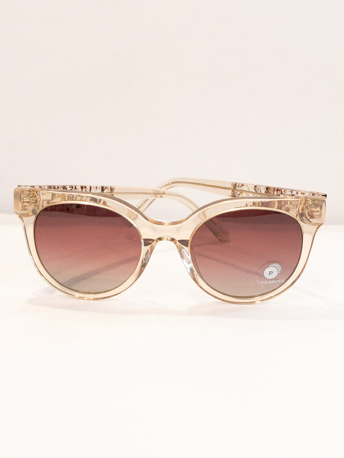 A pair of rose-colored sunglasses with a paisley pattern, displayed against a neutral background.