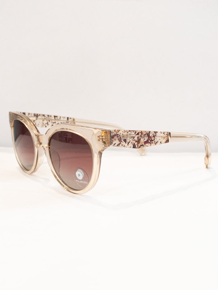 A pair of rose-colored sunglasses with a paisley pattern, displayed against a neutral background.