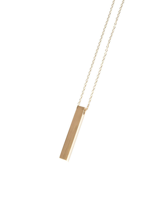 Martin Valen gold-color stainless steel column necklace with vertical bar pendant, angled front view on fine chain