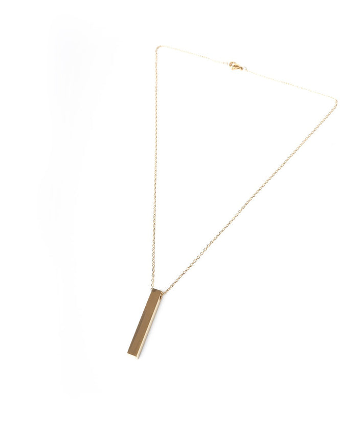 Martin Valen gold-color stainless steel column necklace laid flat showing long vertical pendant and clasp on white background