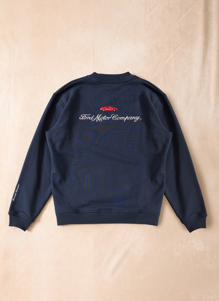 Back of the navy blue Percival x Ford sweatshirt with embroidered Ford Motor Company logo and red car.