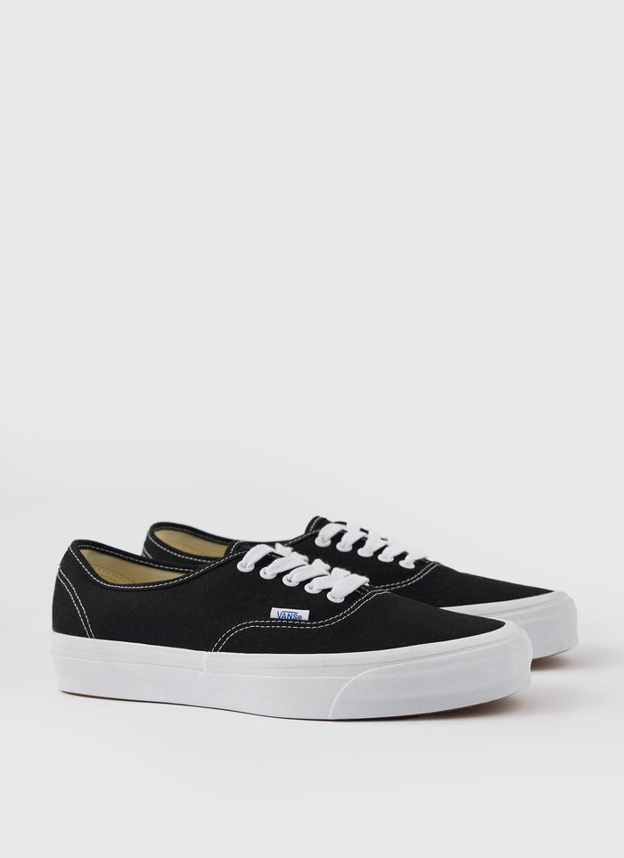 A pair of black Vans Premium Authentic 44 trainers with white laces and soles, shot against a white background for Percival.